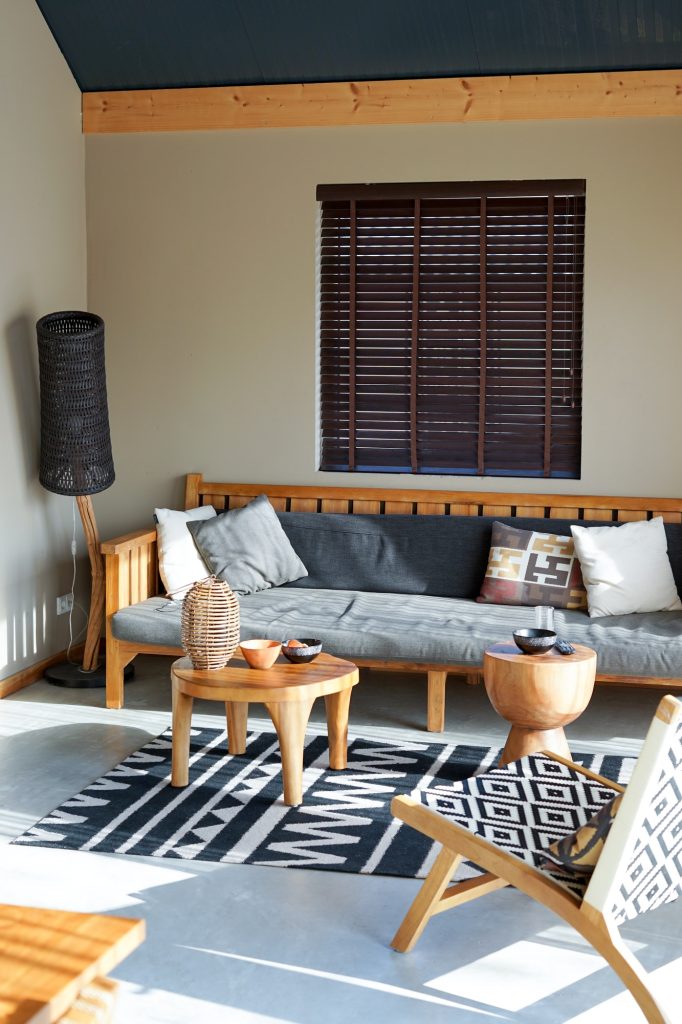 Lodge interior design decorated in comfortable furniture and ethnic details in African style.