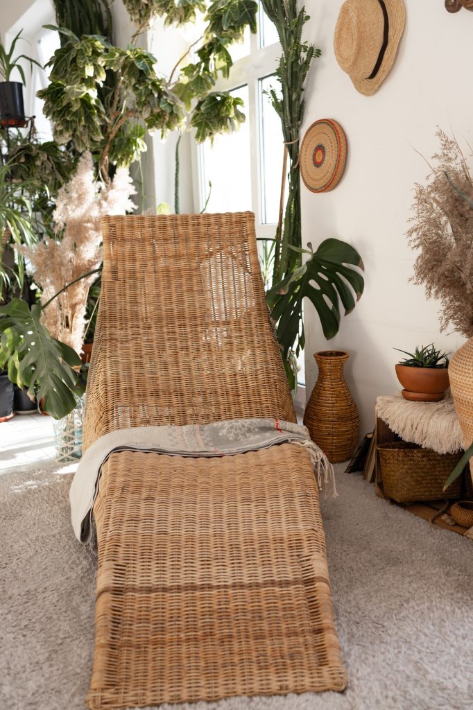 New furniture in cozy living room. Modern interior design in boho apartment. bamboo armchair and pla