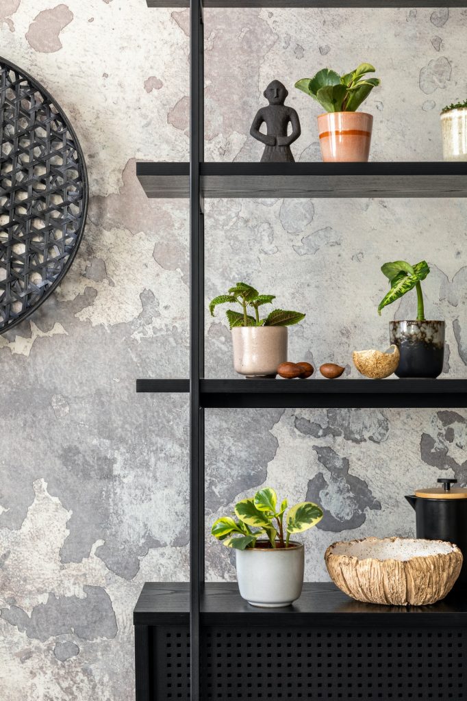The stylish composition of wabi sabi interior with black rack with personal accesoories.