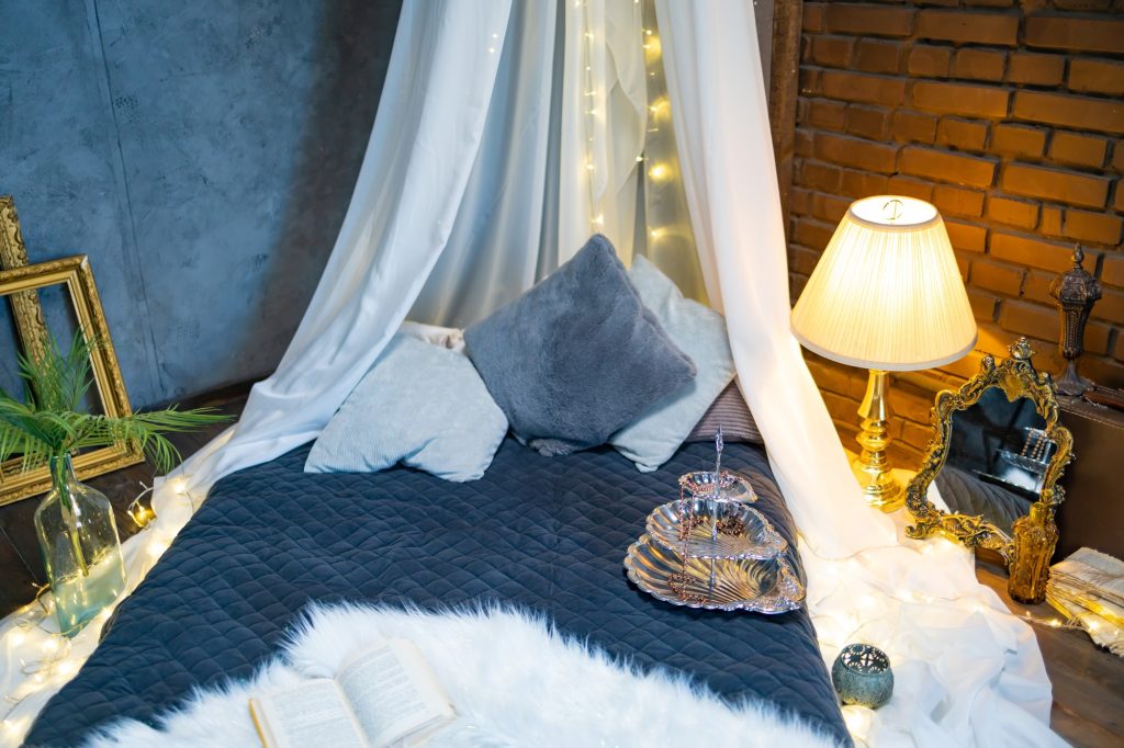 Vintage side bed lamp on the bedside table. Retro bed room interior design.