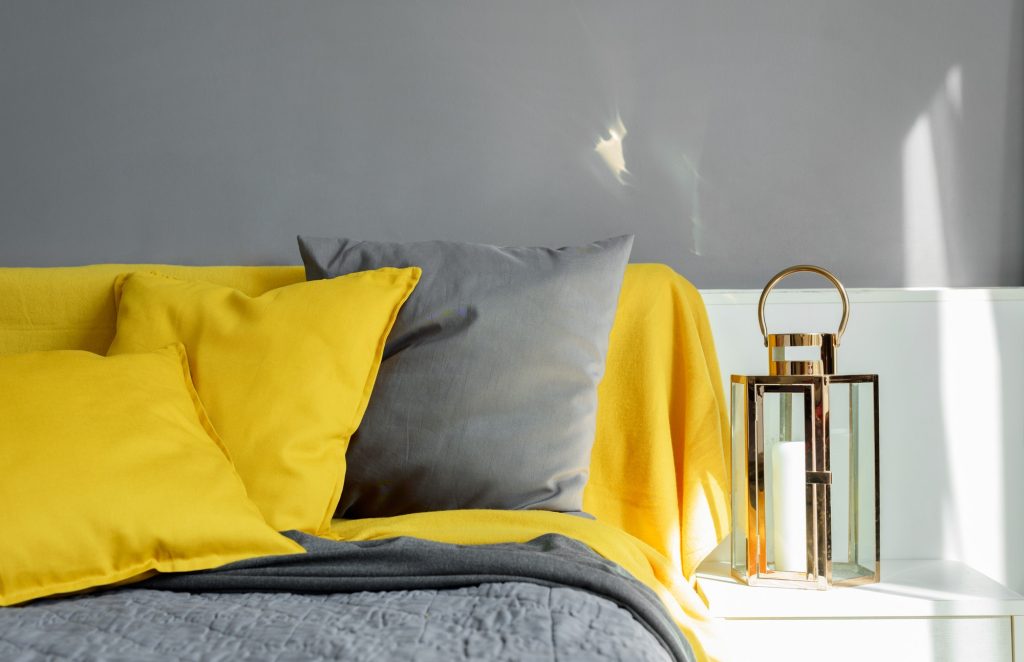 Color pillows illuminating ultimate gray pile on bed Two trendy 2021 colors of years Modern interior