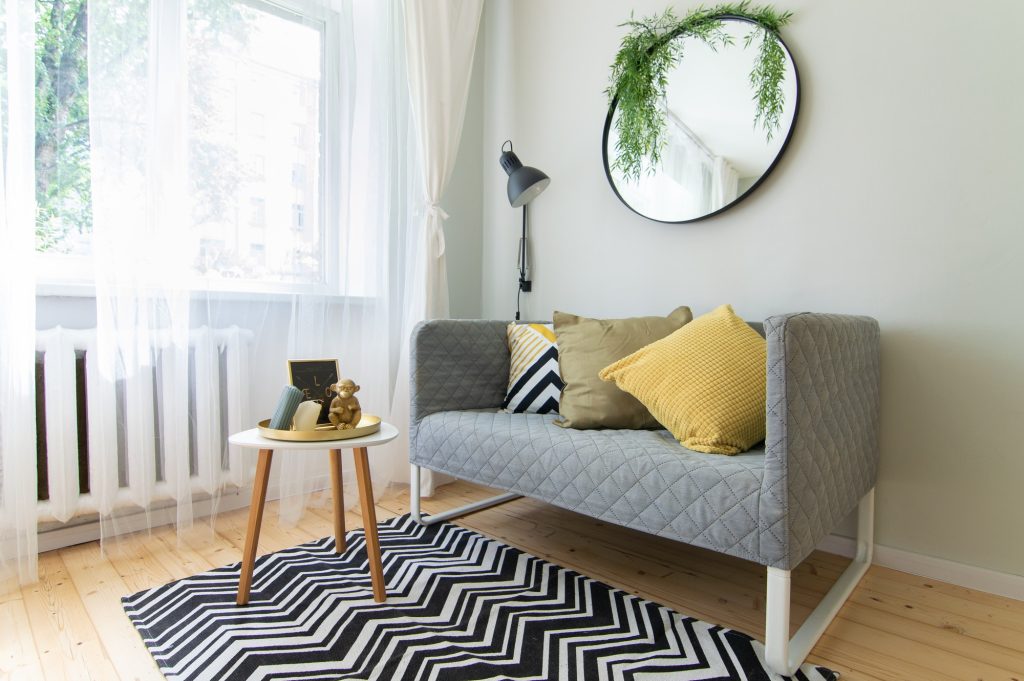 Interior corner for reading and relaxation. Simple furniture consisting of sofa and coffee table
